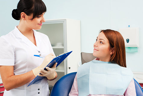 Young female patient smiling at a female dentist
