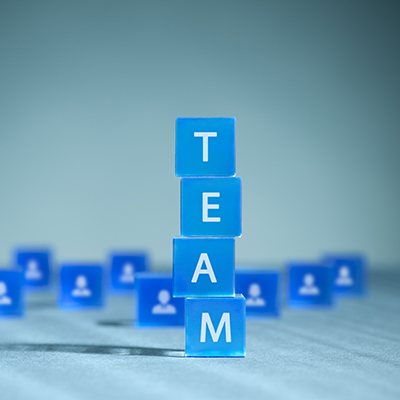 square blue blocks spelling out the word "Team"